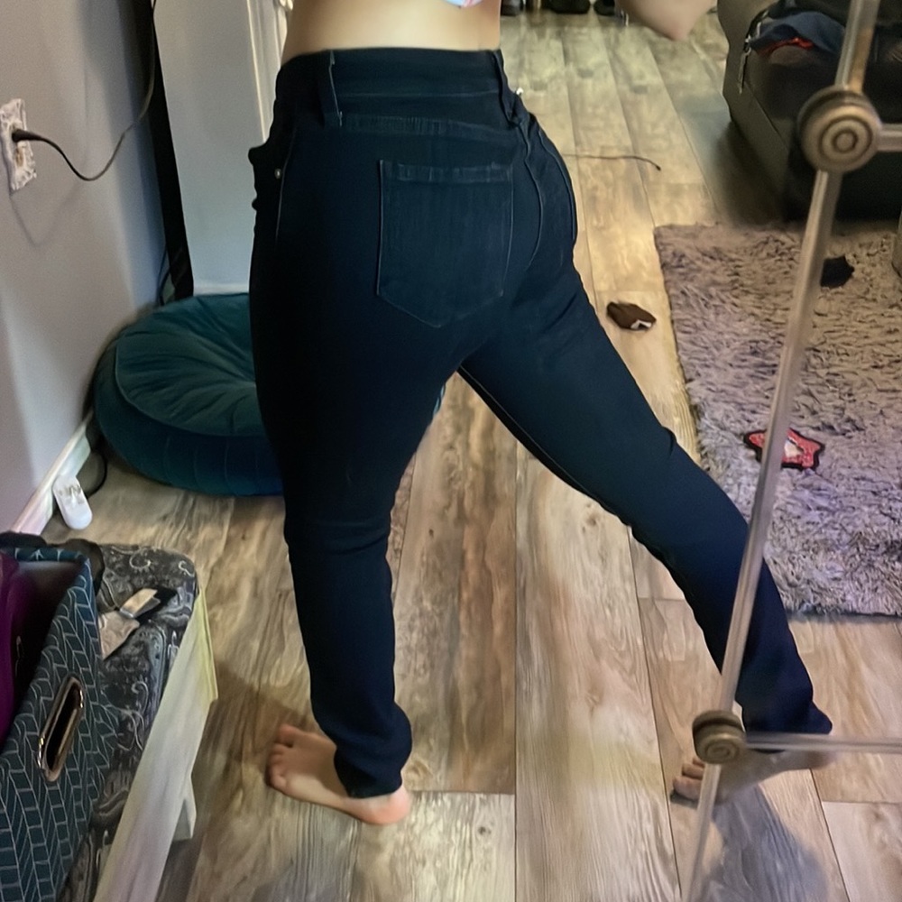 Dark jeans with zippers down the sides